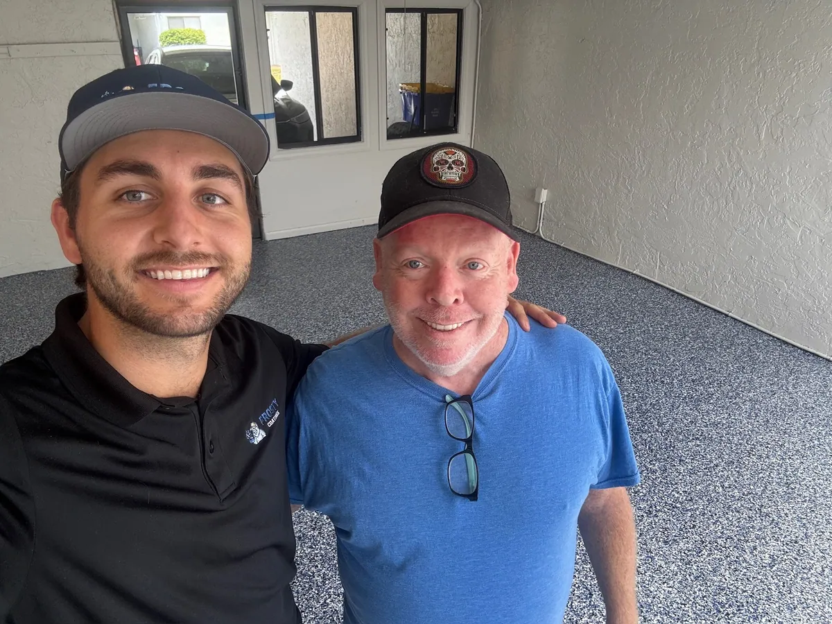 A Frosty Coatings installer with a customer on their new garage floor