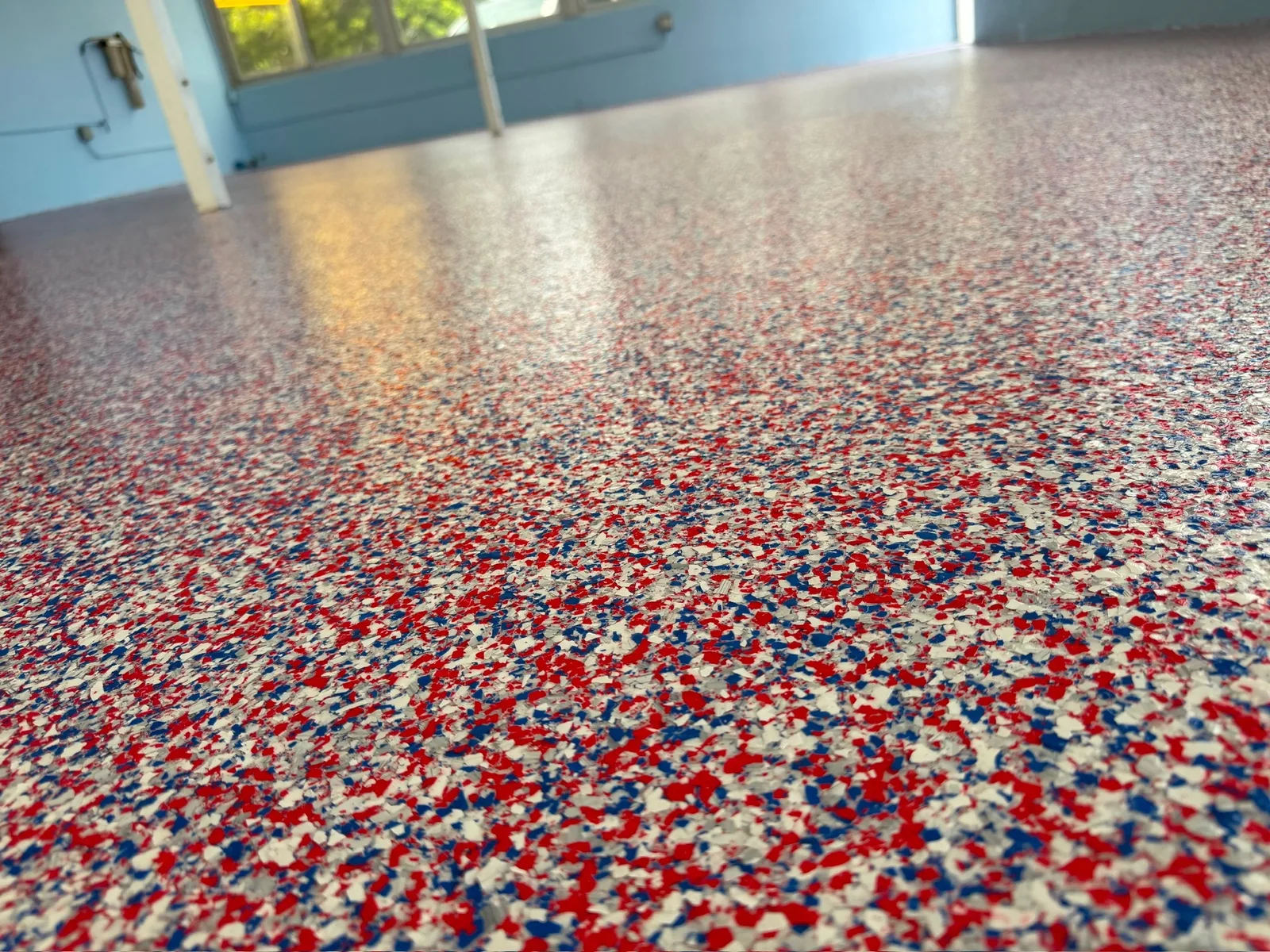 A close view of the red, white and blue flake floor in a restaurant bar