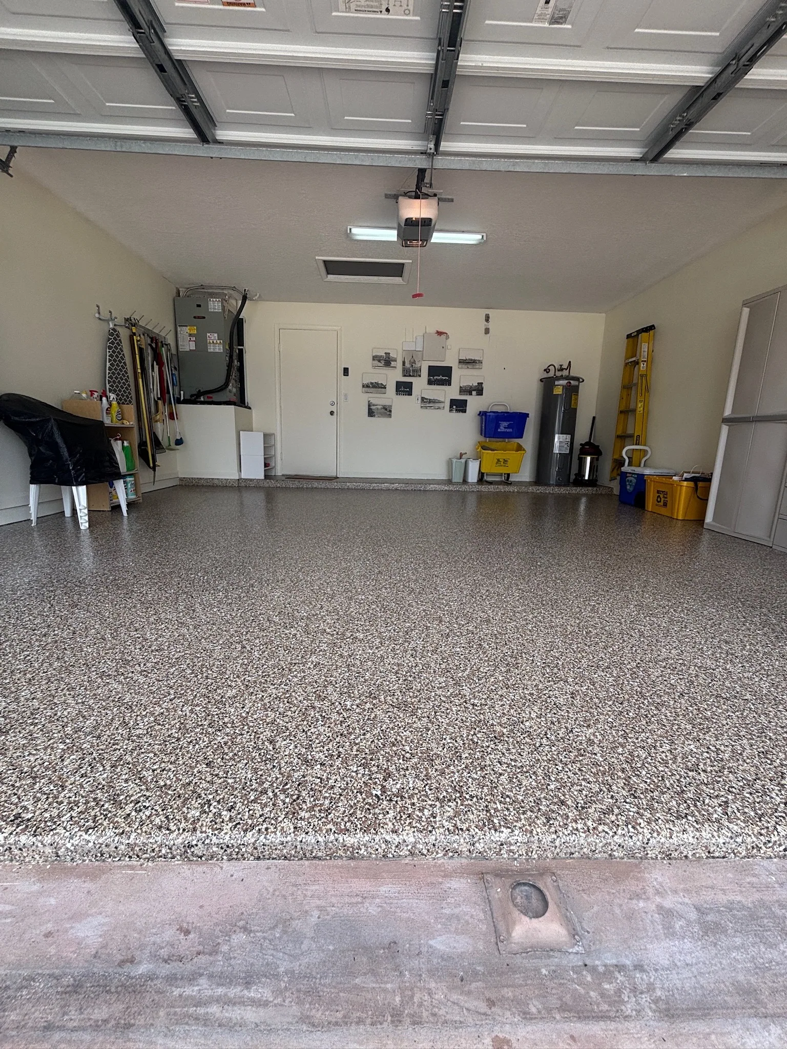 A two car garage finished in a warm flake blend, doors open to the sun