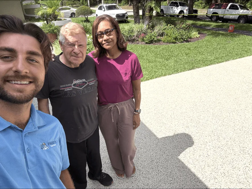 A Frosty Coatings team member with two customers on their finished driveway