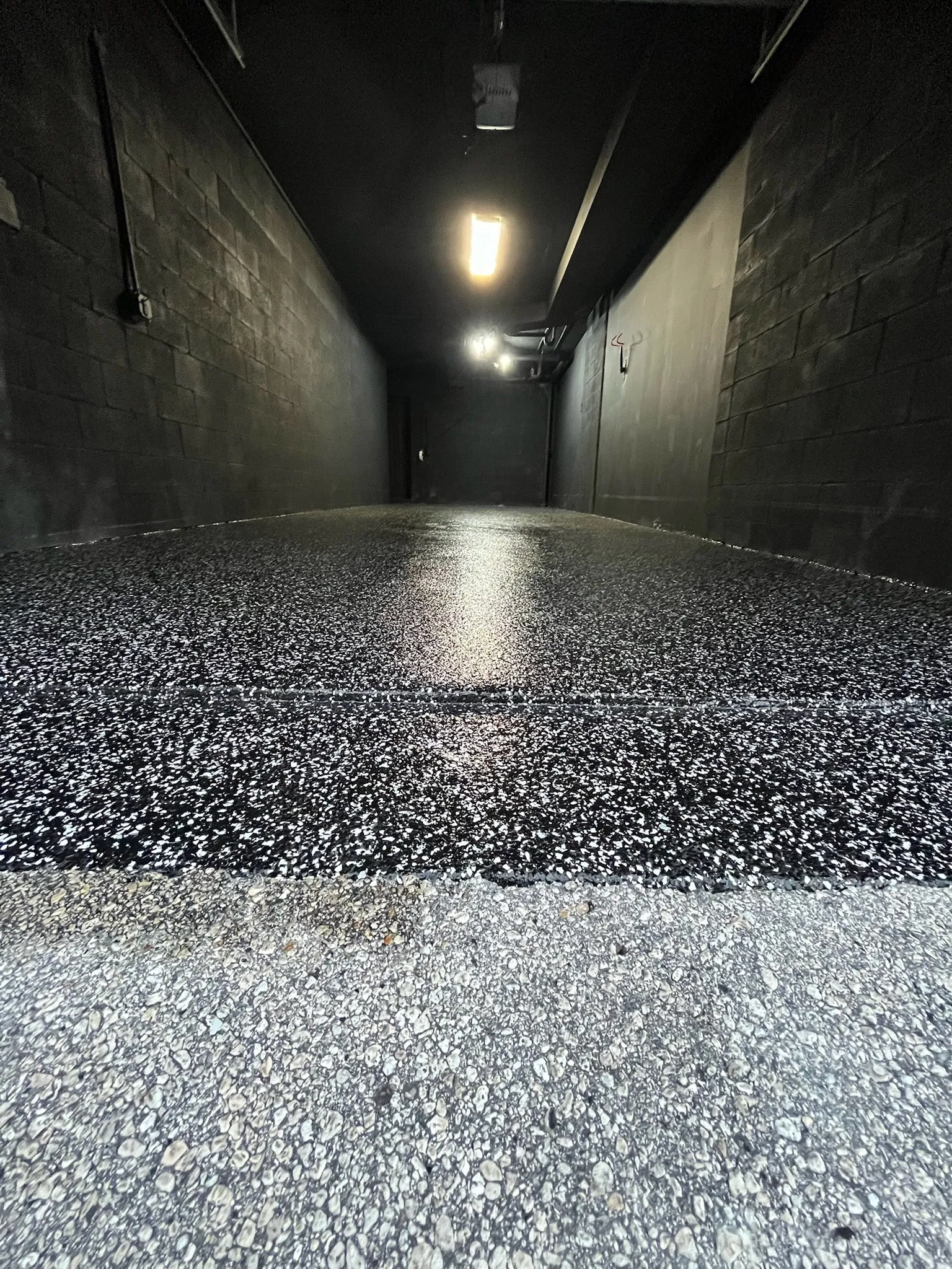Covered walkway finished in a black and white flake system