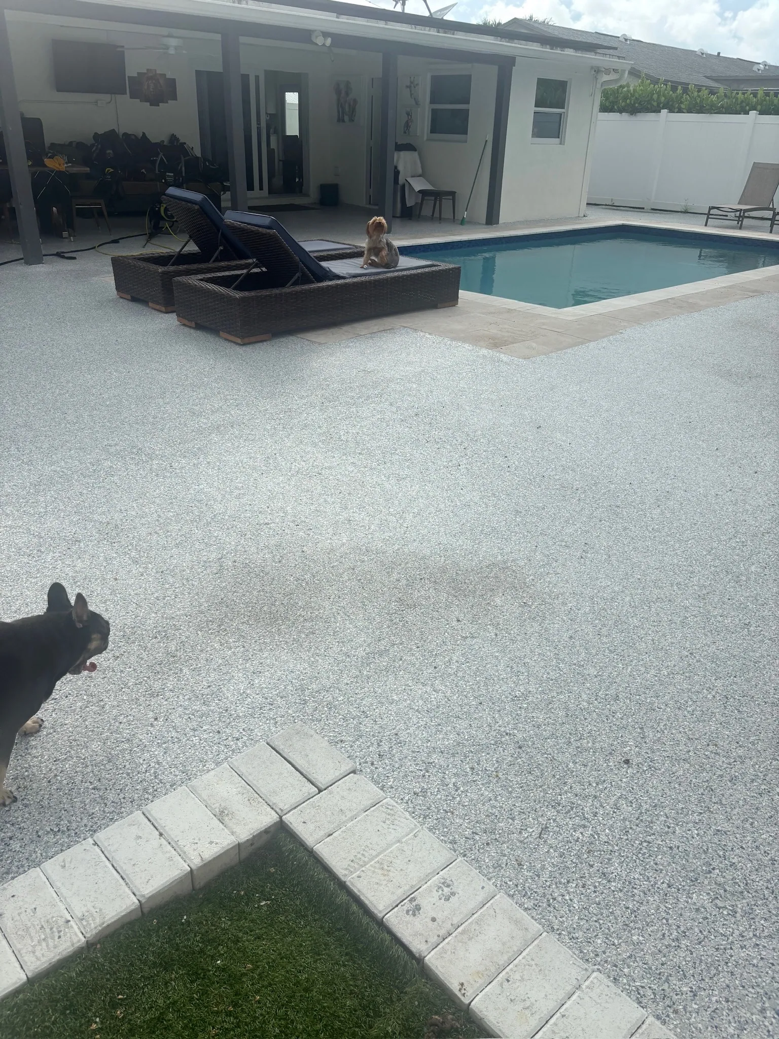 Coated pool deck running from the house to the water